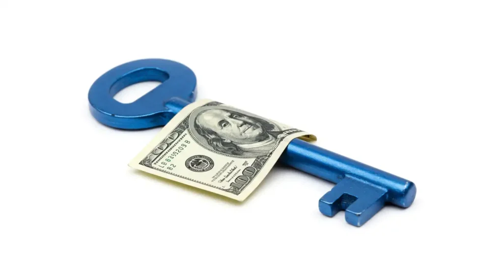 A blue metal key with 100 dollar bill on it.