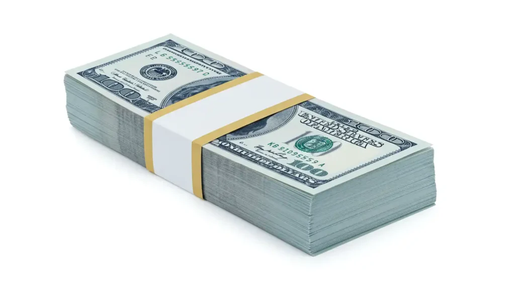 A stack of USD with a yellow and white paper band.